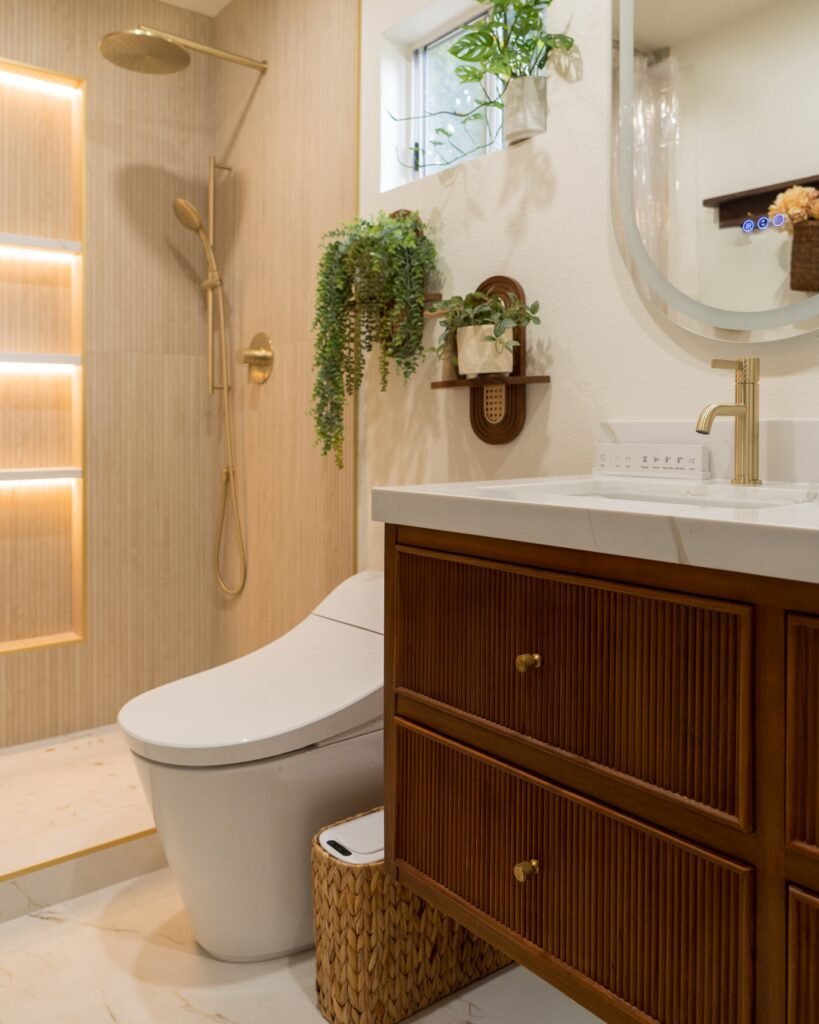 Floating fluted-wood vanity and smart toilet beside the walk-in shower