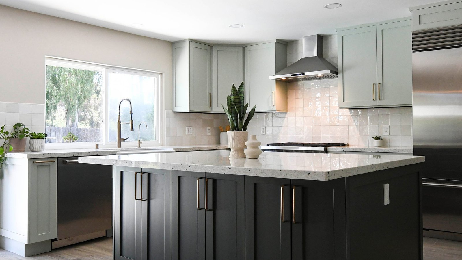 Green kitchen with a charcoal island, remodeled by Royalty Design & Build